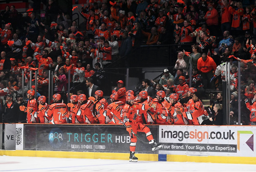 Sheffield Steelers players and supporters beside branded rink boards